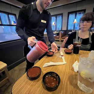 Refilling the salsa with a water pitcher. Genius