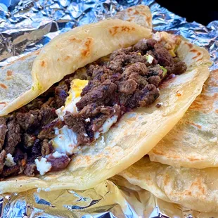 TAKEOUT: Baleada Super w/ eggs, mashed beans, cheese, sour cream, avocado | $5+$1 carne