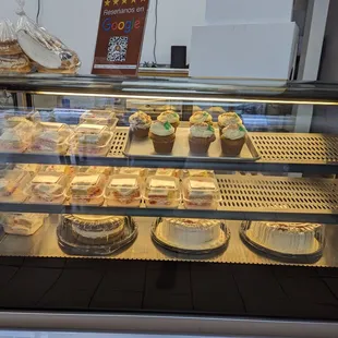 a display case filled with cupcakes