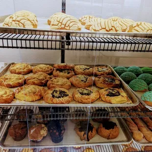 a variety of pastries in a display case