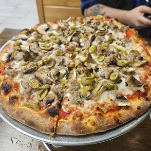 Mushroom, sausage, and green olive pizza