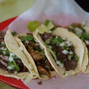 three tacos on a red plate