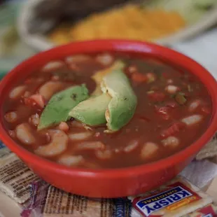 a bowl of chili and avocado