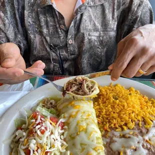 Wet Burrito Plate loaded with carnitas and topped with lots of cheese.