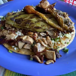 Huarache with Buche (stomach pork).  Flour tortilla loaded with yummy toppings:  pork, onion, cactus, cheese and more!