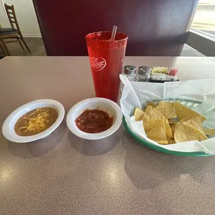 Chips and salsa with refried beans and cheese.