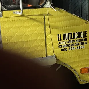 the side of a yellow truck