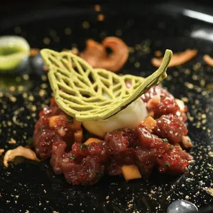 a plate of food on a black plate