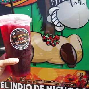 a hand holding a drink