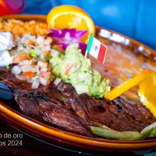 Carne Asada Sliced of Skirt Steak Cooked over Charcoal. Served with Guacamole, Jalapeño &amp; Green Onions.