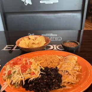 Chicken enchilada, tostada, black beans and rice