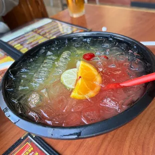 a bowl of soup with a slice of orange