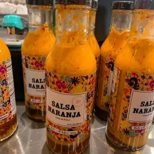 a row of bottles of salsa
