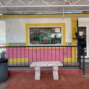 a bench in front of a restaurant