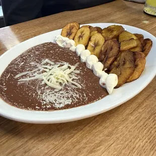 Fried plantain with beans and cream.