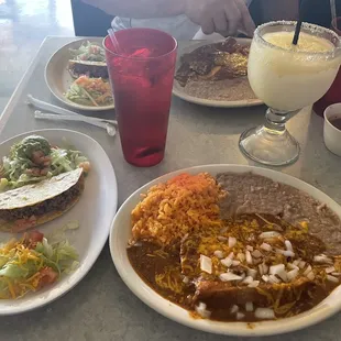 Combo meal with one crispy taco, guacamole salad, one enchilada, one tamale, rice and beans. The fresh onions were a server's suggestion.