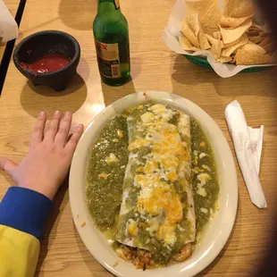 Wet steak and shrimp burrito with green chili sauce