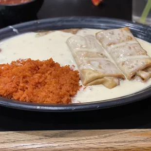 Chicken Chimichanga,Rice,Beans, and of course they're wonderful white cheese all over!!