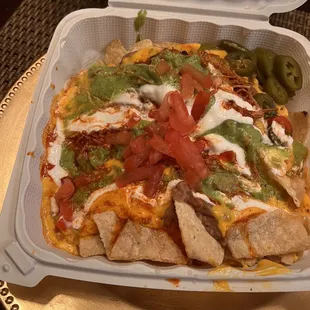 Super Nachos with shredded chicken.