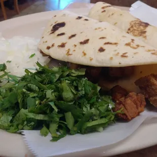Two tacos in flour tortilla! One was medium cooked mollejas and the other medium cooked tripas! With a side of white onion and celantro!