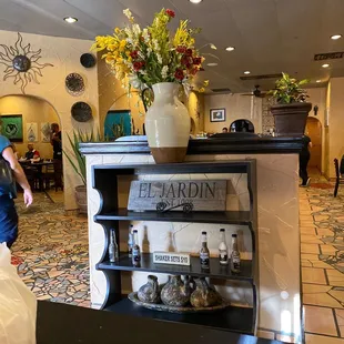 a counter with a vase of flowers on it