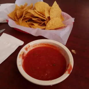a bowl of salsa and chips