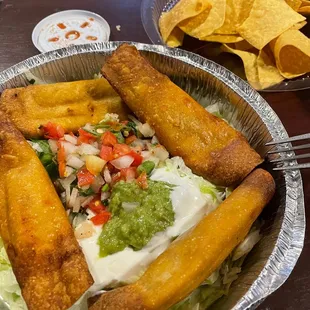 a plate of food and a bowl of chips