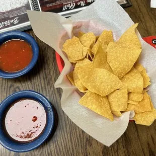 a bowl of tortilla and a bowl of salsa