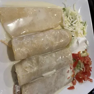 Enchilada special with cheese sauce