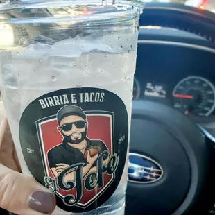 a hand holding a glass of water