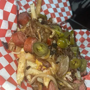 Chili cheese fries with a hotdog and jalapeños