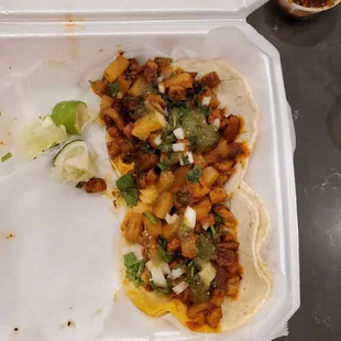 a taco in a styrofoam container