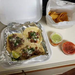 Carnitas, lengua, and al pastor tacos with chips and salsa - delicious and priced right