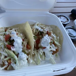 Fish tacos with salsa red and green on the side