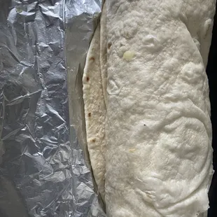 a burrito wrapped in aluminum foil