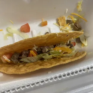 a taco in a styrofoam container