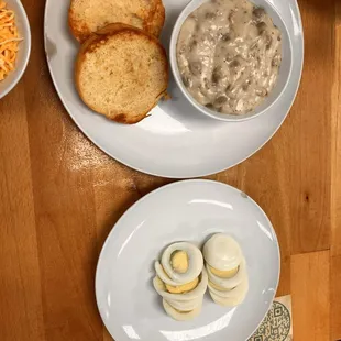 Biscuit and gravy with two boiled eggs