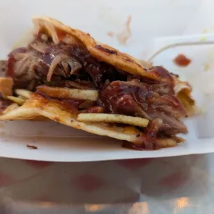 Partially eaten American Taco (a BBQ with pork)