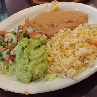 The side of rice, guacamole salad, and beans that accompanies most of the entrees!