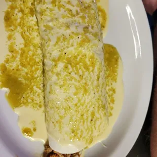 a burrito with cheese and sauce
