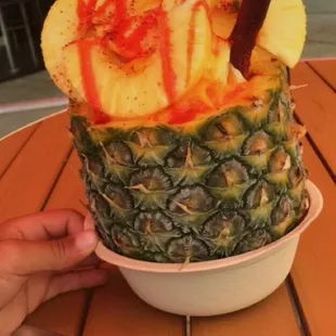 a pineapple topped with fruit