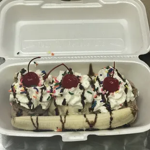 a banana split with whipped cream and cherries