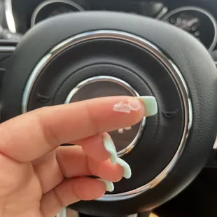 a hand holding a steering wheel knob