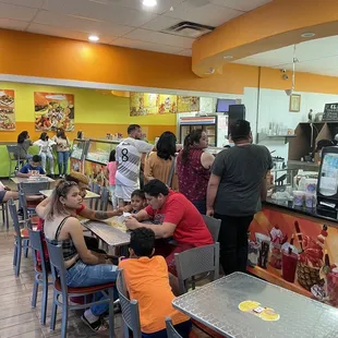 a group of people sitting at tables in a restaurant