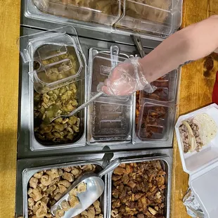 a person putting food into containers