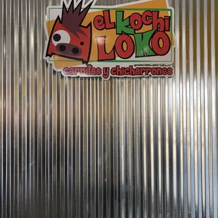 a sticker on a metal wall
