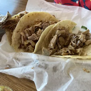 three tacos on a table