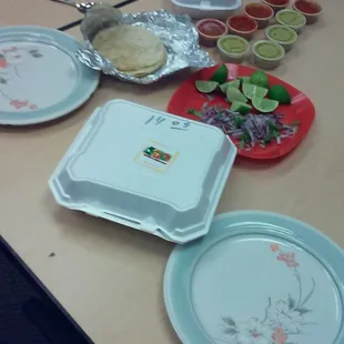 a table with plates and bowls of food