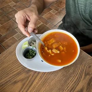 a man eating a bowl of soup