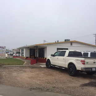 a white truck parked in front of a building